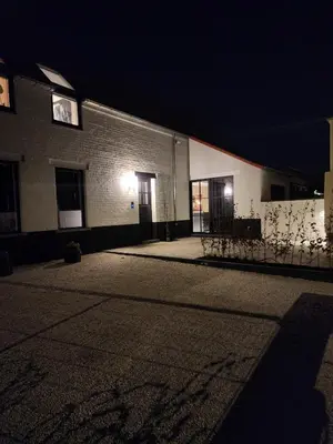 a building with two doors and a street at night at Obobonne in Geraardsbergen