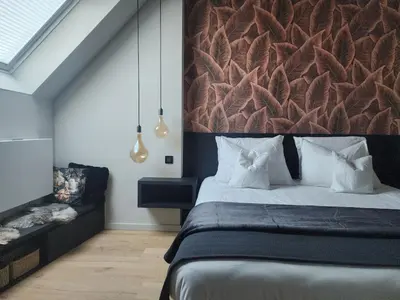 a bedroom with a bed with a large headboard at Obobonne in Geraardsbergen