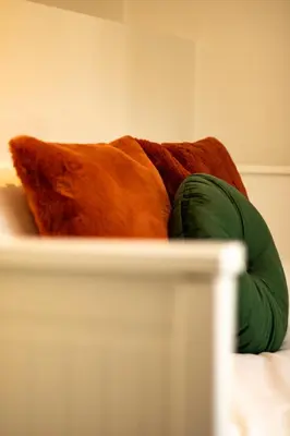 a brown dog laying on top of a bed at Central Ghent Apartment for 3 Guests in Ghent