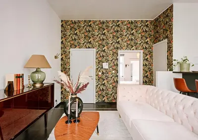 a living room with a white couch and floral wallpaper at Central Ghent Apartment for 3 Guests in Ghent