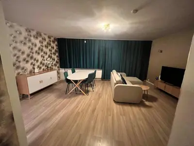 a living room with a couch and a table and chairs at Vilvoorde city center in Vilvoorde