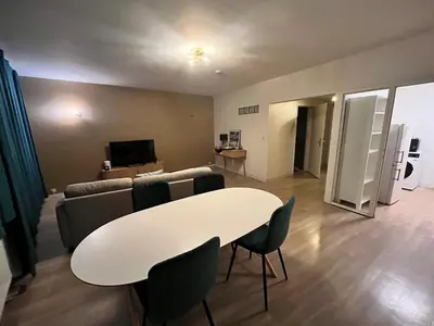 a living room with a white table and a couch at Vilvoorde city center in Vilvoorde