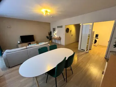 a living room with a white table and a couch at Vilvoorde city center in Vilvoorde