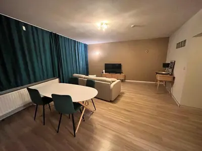 a living room with a table and a couch at Vilvoorde city center in Vilvoorde