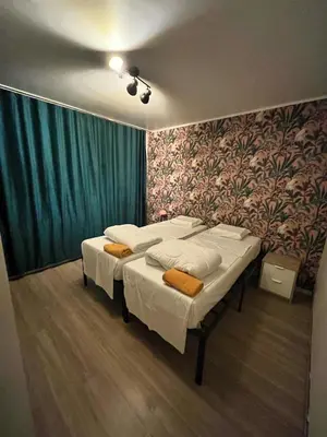 a room with two beds in it with a wall at Vilvoorde city center in Vilvoorde