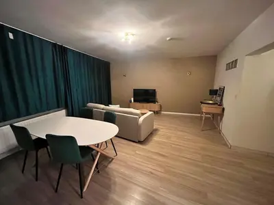 a living room with a couch and a table and chairs at Vilvoorde city center in Vilvoorde