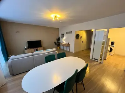 a living room with a white table and a couch at Vilvoorde city center in Vilvoorde