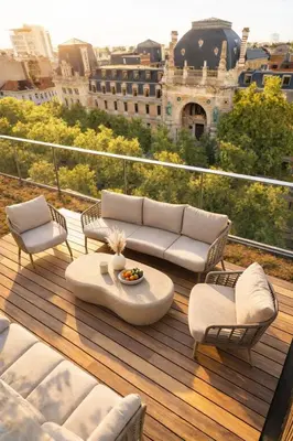a patio with a couch and chairs on a balcony at Luxury penthouse in Antwerp in Antwerp