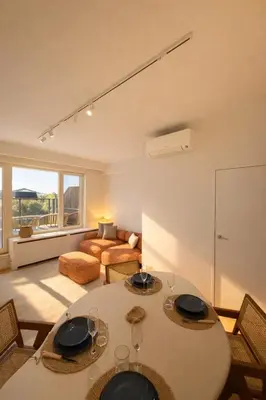 a living room with a table and chairs and a couch at Luxury penthouse in Antwerp in Antwerp