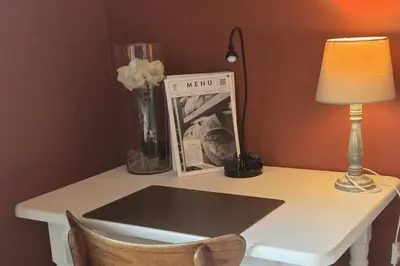 a desk with a lamp and a book on it at Green Hill Guest Room Overijse in Overijse