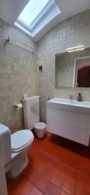 a bathroom with a toilet and a tub and a sink at Green Hill Guest Room Overijse in Overijse
