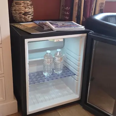 two bottles of water in an empty refrigerator at Green Hill Guest Room Overijse in Overijse