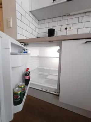 an open refrigerator with drinks inside of it at Studio charmoso in Brussels