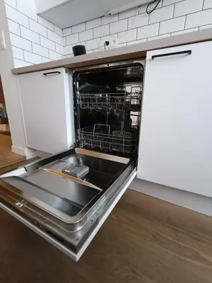 a kitchen with an open dishwasher in a kitchen at Studio charmoso in Brussels