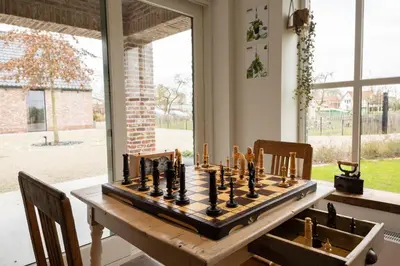 a chess board on a table in a room at Vakantiehoeve Breathe Nature in Lochristi