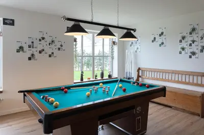 a room with a pool table with balls on it at Vakantiehoeve Breathe Nature in Lochristi