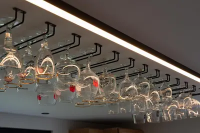 a chandelier with wine glasses hanging from a ceiling at Vakantiehoeve Breathe Nature in Lochristi