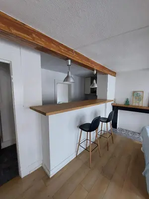 a kitchen with two chairs and a counter in a room at Typical flat Grand Place in Brussels