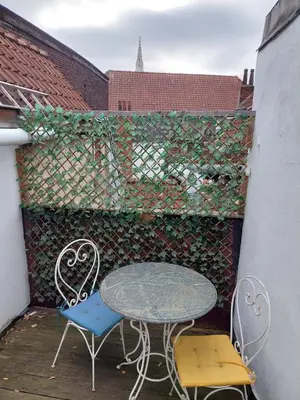 a table and two chairs sitting on a patio at Typical flat Grand Place in Brussels