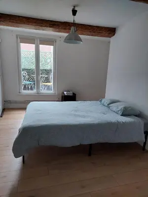a bedroom with a large bed in front of a window at Typical flat Grand Place in Brussels