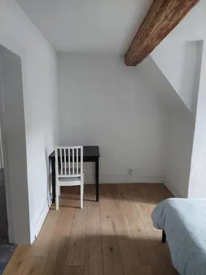 a bedroom with a desk and a chair in a room at Typical flat Grand Place in Brussels
