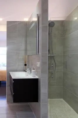 a bathroom with a sink and a shower at Parc Brussels Apartment in Brussels