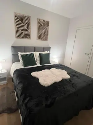 a bedroom with a bed with a white towel on it at Secret Garden 2