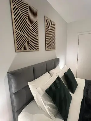 a bedroom with a bed with black and white pillows at Secret Garden 2
