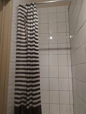 a black and white shower curtain in a bathroom at Deurne in Antwerp