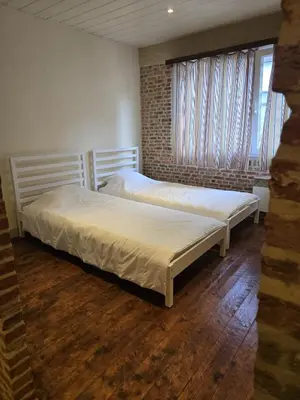 two twin beds in a room with a window at Schijnpoort in Antwerp