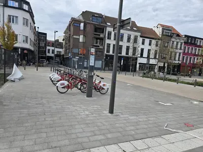 a row of bikes parked on a city street at Schijnpoort in Antwerp