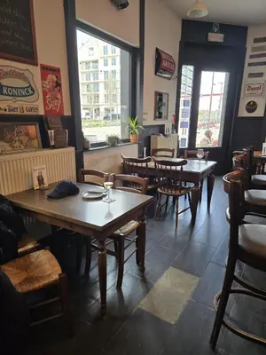a dining room with tables and chairs in a restaurant at Schijnpoort in Antwerp