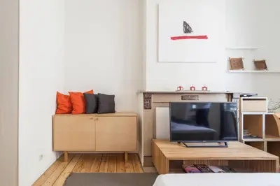 a living room with a tv and a couch at 1 Bedroom W Kitchen and Bathroom In Trendy St Gilles in Brussels