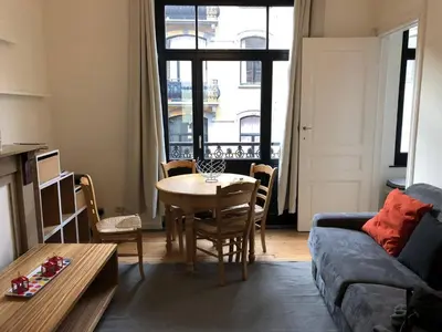 a living room with a table and a couch at 1 Bedroom W Kitchen and Bathroom In Trendy St Gilles in Brussels