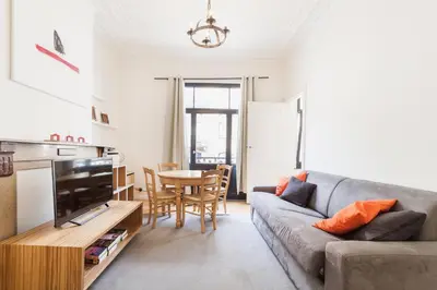 a living room with a couch and a table at 1 Bedroom W Kitchen and Bathroom In Trendy St Gilles in Brussels