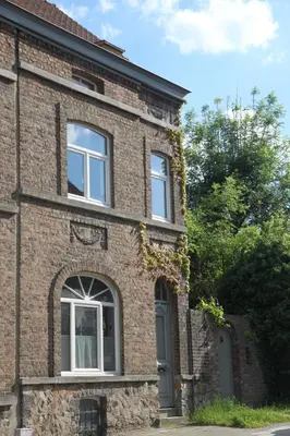 a brick building with a door and windows at Furnished house BXL- for team of workers in Beersel