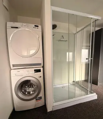 a washing machine with a glass door next to a washer at Cozy home in Zottegem in Zottegem