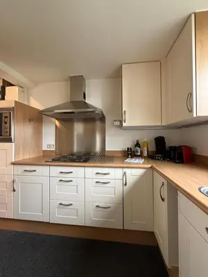 a kitchen with white cabinets and a stove top oven at Cozy home in Zottegem in Zottegem
