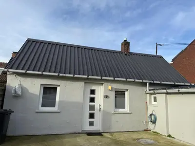 a white house with a black roof at Cozy home in Zottegem in Zottegem