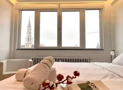 a hotel room with a bed with towels on it at Grand Place Bourse Prestige in Brussels