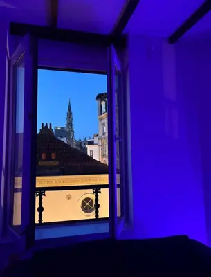 a room with a window with a view of a city at Grand Place Bourse Prestige in Brussels