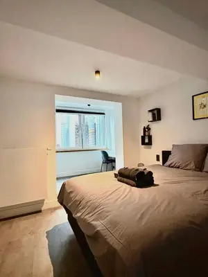 a bedroom with a large bed and a window at Grand Place Bourse Prestige in Brussels