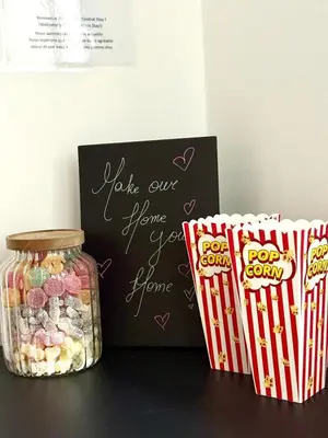 a chalkboard with a sign and some popcorn and a jar of candy at Grand Place Bourse Prestige in Brussels