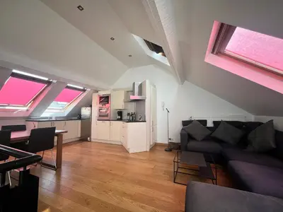 a living room with a couch and a table at MetztliBru in Brussels