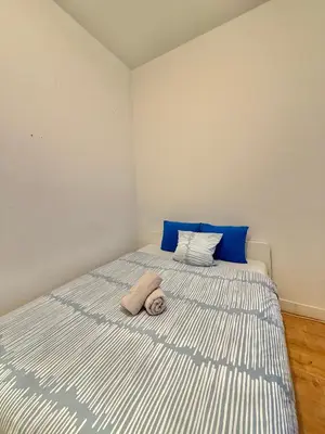 a bedroom with a bed with a stuffed animal on it at Centre ville de Bruxelles in Brussels