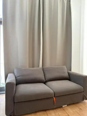 a couch sitting in front of a curtain at Centre ville de Bruxelles in Brussels