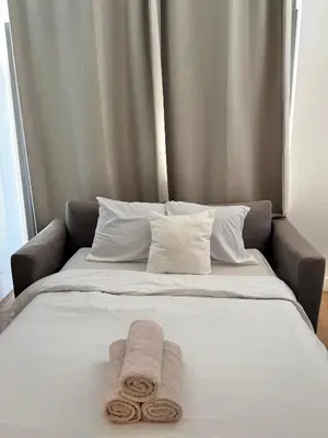 a bed with two towels on top of it at Centre ville de Bruxelles in Brussels