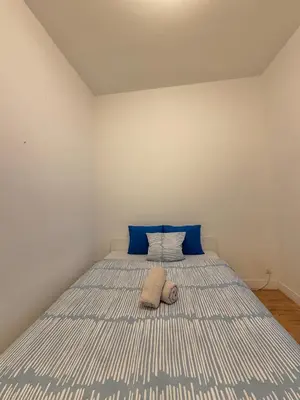 a bedroom with a bed with a blue and white stripes at Centre ville de Bruxelles in Brussels