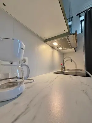 a kitchen with a white counter top and a sink at Centre ville de Bruxelles in Brussels