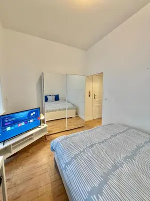 a bedroom with a bed and a flat screen tv at Centre ville de Bruxelles in Brussels